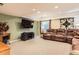 Spacious living room featuring a sofa, a mounted tv, and an area rug at 8385 Briar Trace Dr, Castle Pines, CO 80108