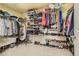 Large walk-in closet featuring metal shelving, clothing racks and full length mirror at 8385 Briar Trace Dr, Castle Pines, CO 80108