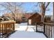 Snowy backyard with detached garage and wooden deck at 1340 N Gilpin St, Denver, CO 80218