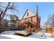 Brick home with backyard deck and snowy yard at 1340 N Gilpin St, Denver, CO 80218