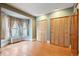 Bedroom with hardwood floors, bay window, and built-in closet at 1340 N Gilpin St, Denver, CO 80218