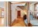 Grand entryway with wood staircase, hardwood floors, and floral wallpaper at 1340 N Gilpin St, Denver, CO 80218