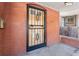 Ornate front door with black security gate, brick entryway at 1340 N Gilpin St, Denver, CO 80218