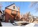 Brick house with a large deck and snowy backyard at 1340 N Gilpin St, Denver, CO 80218