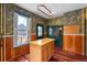 Kitchen with wood cabinets, island, and wood floors at 1340 N Gilpin St, Denver, CO 80218