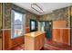 Kitchen with wood cabinets, island, and wood floors at 1340 N Gilpin St, Denver, CO 80218