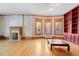 Living room with hardwood floors, bay windows, and built-in bookcase at 1340 N Gilpin St, Denver, CO 80218