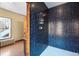 Walk-in shower with blue tile and wood accents at 1340 N Gilpin St, Denver, CO 80218