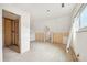 Unfinished bedroom featuring drywall, wood framing, and a window providing natural light and architectural interest at 796 S Bristol St, Lakewood, CO 80228