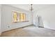 A bright bedroom needing renovation featuring a chandelier and a window perfect for natural light at 796 S Bristol St, Lakewood, CO 80228
