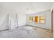 A bedroom under renovation offers a view of potential with a large window and door to another room at 796 S Bristol St, Lakewood, CO 80228