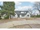 Charming single-Gathering home with a white brick exterior and a gray roof at 796 S Bristol St, Lakewood, CO 80228