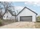 Angle shot of a well-maintained home, showing the garage, white siding, black trim, and concrete driveway at 796 S Bristol St, Lakewood, CO 80228