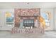 A classic brick fireplace, ready for renovation, with a wooden mantle serves as a focal point at 796 S Bristol St, Lakewood, CO 80228