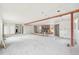Spacious living room under renovation features exposed beams and a brick fireplace, ready for customization at 796 S Bristol St, Lakewood, CO 80228