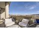 Balcony featuring mountain views, white patio furniture, and decorative pots at 20 Wilcox St # 308, Castle Rock, CO 80104