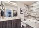 Modern bathroom with wood vanity, decorative tile shower, soaking tub, and tiled floor at 20 Wilcox St # 308, Castle Rock, CO 80104