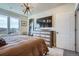 Spacious bedroom featuring a large window, modern dresser, and a sleek TV at 20 Wilcox St # 308, Castle Rock, CO 80104