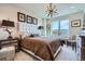 Comfortable bedroom with a tufted headboard, stylish lighting, and a scenic view at 20 Wilcox St # 308, Castle Rock, CO 80104