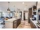 Modern kitchen featuring an island with quartz countertop, stainless steel appliances, and stylish pendant lighting at 20 Wilcox St # 308, Castle Rock, CO 80104