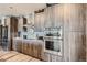 Kitchen with custom wood cabinets, stainless steel appliances, and a stylish backsplash at 20 Wilcox St # 308, Castle Rock, CO 80104