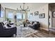 Modern living room with dark wood floors, stylish couches and bright natural light at 20 Wilcox St # 308, Castle Rock, CO 80104