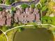 Aerial view of townhomes nestled by a pond with landscaped common areas in a community setting at 3240 W 114Th Cir # D, Westminster, CO 80031