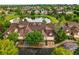 Lovely aerial view of townhomes overlooking a pond, surrounded by manicured lawns and mature trees at 3240 W 114Th Cir # D, Westminster, CO 80031