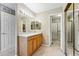 Bathroom featuring a wooden vanity, a large mirror, and a glass-enclosed shower at 3240 W 114Th Cir # D, Westminster, CO 80031