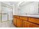 Bathroom features a tiled floor, shower and wooden vanity with a large mirror at 3240 W 114Th Cir # D, Westminster, CO 80031