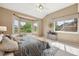Comfortable bedroom with vaulted ceilings, a ceiling fan, and large windows overlooking the serene landscape at 3240 W 114Th Cir # D, Westminster, CO 80031