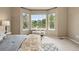 A bedroom boasting a sunlit bay window with a view, complemented by stylish furnishings at 3240 W 114Th Cir # D, Westminster, CO 80031
