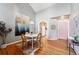 Dining area with wood floors, unique light fixture, and an arched doorway to kitchen at 3240 W 114Th Cir # D, Westminster, CO 80031