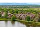 Inviting townhomes near a tranquil lake, with scenic views of trees and distant mountains at 3240 W 114Th Cir # D, Westminster, CO 80031