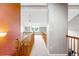 Hallway featuring carpet, wood railings, and access to upper floors with a ceiling fan overhead at 3240 W 114Th Cir # D, Westminster, CO 80031