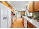 Traditional kitchen with wooden cabinets, modern appliances, and bright natural lighting at 3240 W 114Th Cir # D, Westminster, CO 80031