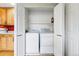 Convenient laundry closet with appliances and storage shelving is located just off the kitchen at 3240 W 114Th Cir # D, Westminster, CO 80031