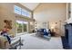 Bright living room boasts vaulted ceilings, large windows, and a cozy fireplace with modern furnishings at 3240 W 114Th Cir # D, Westminster, CO 80031