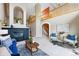 Spacious living room with a black brick fireplace, arched doorways, and views to the second floor at 3240 W 114Th Cir # D, Westminster, CO 80031