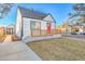 House exterior with a red door and well-maintained lawn at 141 S Knox Ct, Denver, CO 80219