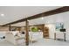 Finished basement with exposed beams, stone wall, a seating area and a home workout space at 2765 W Denver Pl, Denver, CO 80211