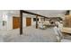 Spacious finished basement with exposed wooden beams and stone accent wall, perfect for entertaining at 2765 W Denver Pl, Denver, CO 80211