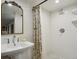 Stylish bathroom featuring a shower with elegant fixtures and tiled walls, next to sink at 2765 W Denver Pl, Denver, CO 80211