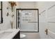Bathroom with shower tub, white tiled walls, and black vanity at 2765 W Denver Pl, Denver, CO 80211