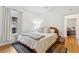 Bright bedroom with hardwood floors, soft area rug, large window and neutral paint colors, creating a calm atmosphere at 2765 W Denver Pl, Denver, CO 80211