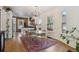 Open dining area with stylish glass table, six chairs, and decorative lighting with large windows at 2765 W Denver Pl, Denver, CO 80211