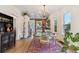 Elegant dining room with hardwood floors, modern chandelier, and an open floor plan at 2765 W Denver Pl, Denver, CO 80211