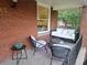 Inviting front porch with brickwork, porch swing and comfortable seating around a fire pit at 2765 W Denver Pl, Denver, CO 80211