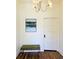 Bright hallway with hardwood floors, decorative lighting, and art piece with a tufted green bench at 2765 W Denver Pl, Denver, CO 80211