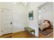 Bright hallway with hardwood floors, decorative lighting, and art piece leading into the bedroom at 2765 W Denver Pl, Denver, CO 80211